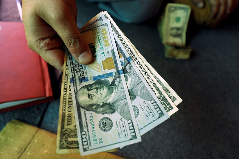 Dollar hands back overnight gains; Fed speakers remain hawkish